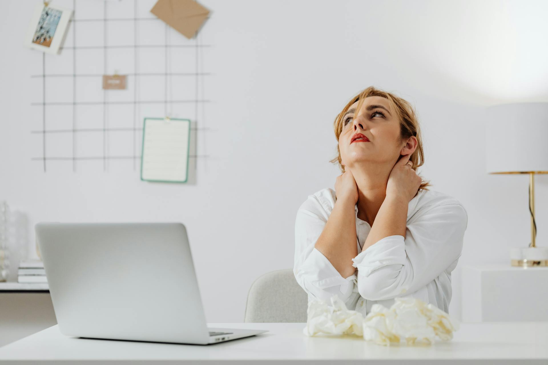 stressed woman is sitting in front of a computer